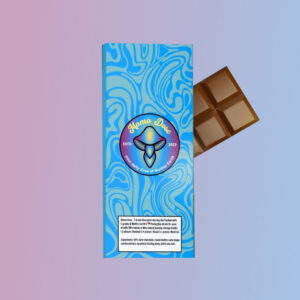 A blue-wrapped Mama's 5g Chocolate Macrodose Journey Bar with a marbled design and colorful emblem. The wrapper is slightly open, revealing some of the chocolate inside.