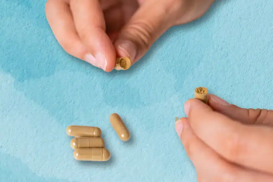 hands holding microdosing capsules 