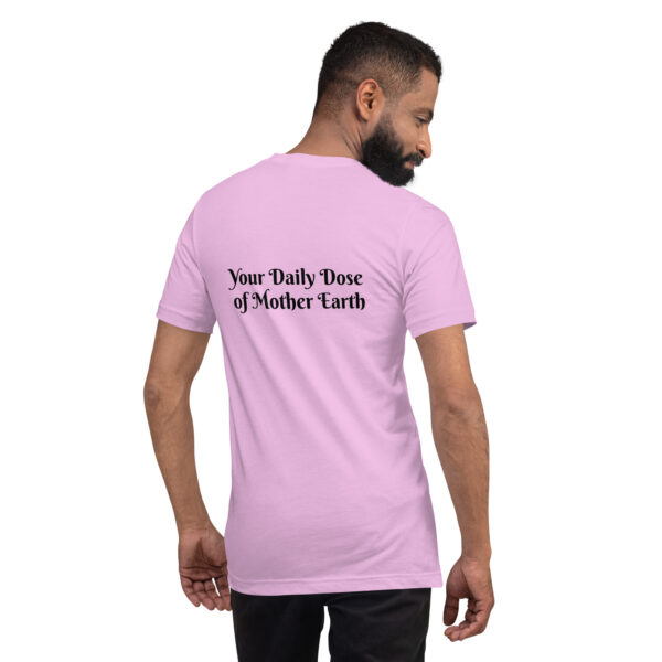 A man with short dark hair and a beard is wearing a "Black & White Mushroom T-Shirt" in pink, featuring the text "Your Daily Dose of Mother Earth" on the back, standing against a plain white background.