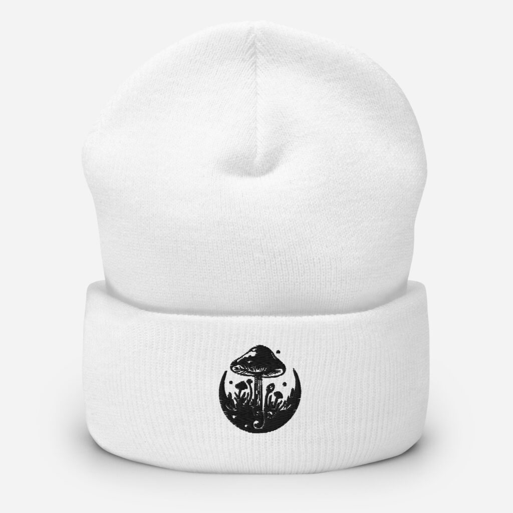 White cuffed beanie featuring a black mushroom design on the fold.