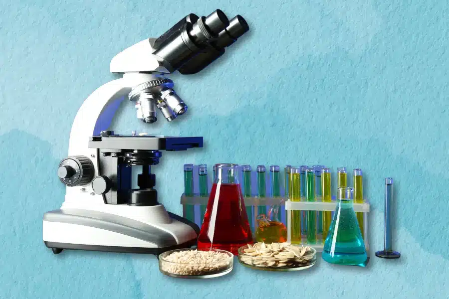 MICRODOSING 101 2 A microscope is accompanied by flasks, test tubes with colored liquids, and petri dishes containing seeds, set against a light blue background.