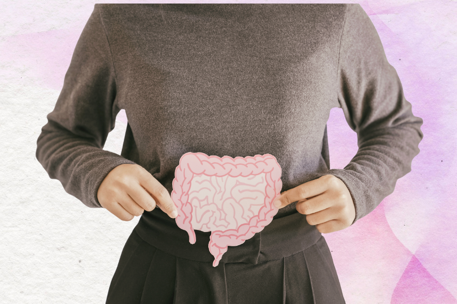Person wearing a sweater points to an illustrated digestive tract overlay on their abdomen against a pastel background.